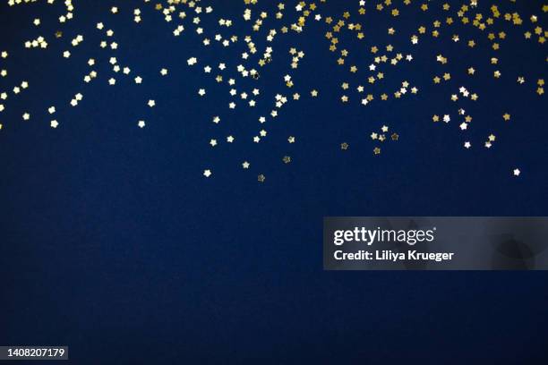 gold bokeh on a blue background. - blue glitter stock pictures, royalty-free photos & images