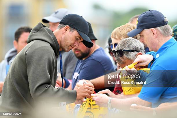Adam Scott of Australia signs autographs for spectators during a practice round prior to The 150th Open at St Andrews Old Course on July 12, 2022 in...