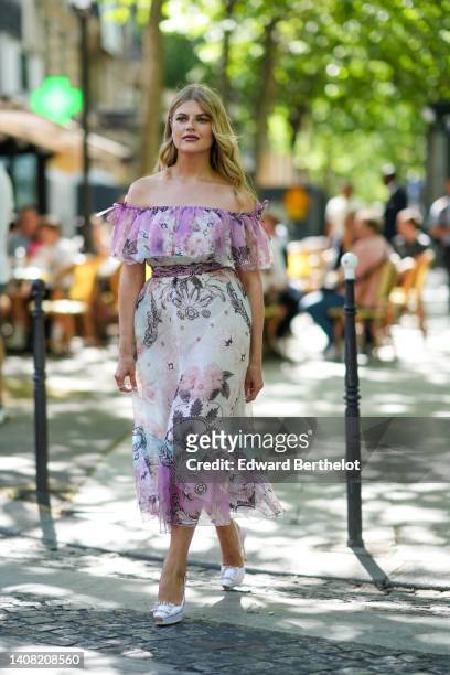 Guest wears a pale purple and white flower print pattern ruffled shoulder-off / midi dress, a diamonds ring, white satin pumps heels shoes with...