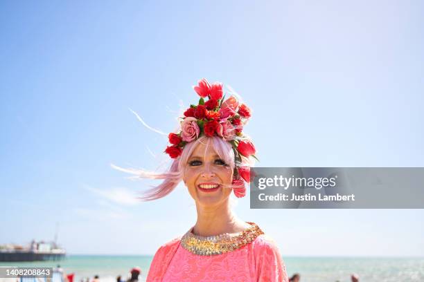 woman wearing colourful flower hair garland looking to camera - junge frau strand sand springen stock-fotos und bilder