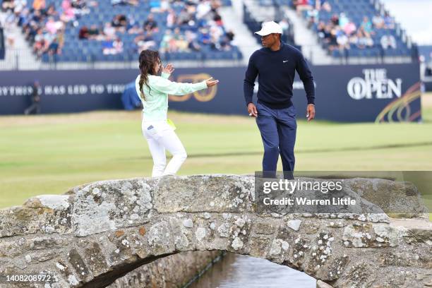 Tiger Woods of The United States looks on alongside Partner Erica Herman during a practice round prior to The 150th Open at St Andrews Old Course on...