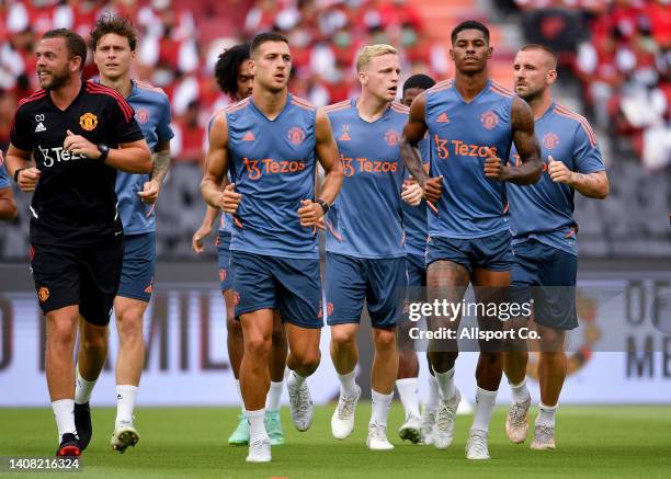 Manchester United players warm up during their open training session prior to the pre-season tour match against Liverpool on the 12th of July, 2022...