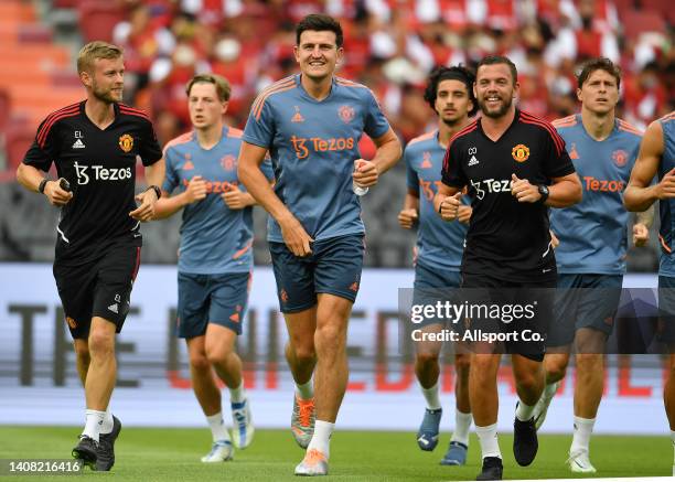 Manchester United players lead by Harry Maguire warms up during their open training session prior to the pre-season tour match against Liverpool on...