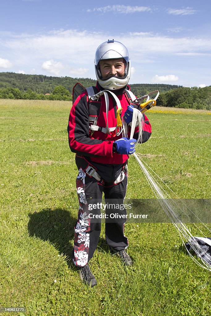 Man over fifty is happy after a parachute landing