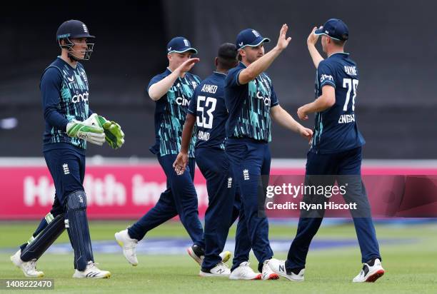 Sam Hain congratulates David Payne of England Lions after catching out Rassie van der Dussen of South Africa during the tour match between England...