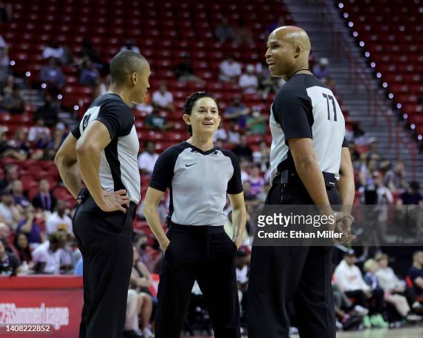 Referees Robert Hussy and Cheryl Flores and ESPN sports analyst and former NBA player Richard Jefferson talk on the court as Jefferson joins them to...