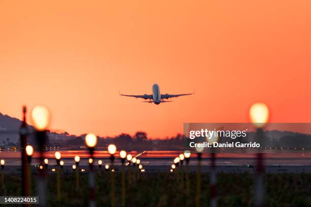 airplane taking off at sunrise, travel and tourism - airplane stock-fotos und bilder