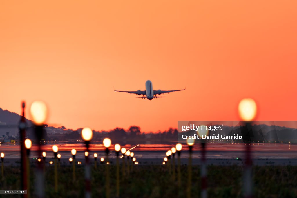Airplane taking off at sunrise, travel and tourism