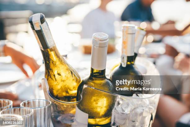 bottle of wine in ice bucket. - aperitif stockfoto's en -beelden