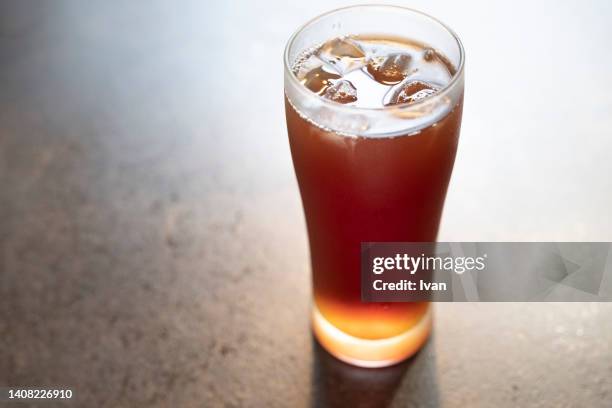 glass of iced tea  on wooden table - tea glass table bildbanksfoton och bilder