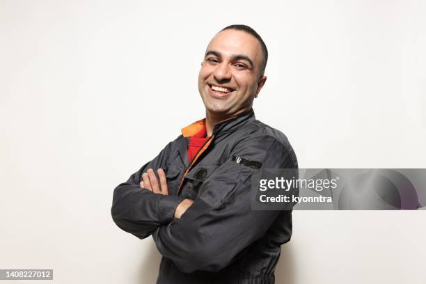 portraits of middle eastern confident middleaged man looking at camera and laughing - mid adult men stock pictures, royalty-free photos & images