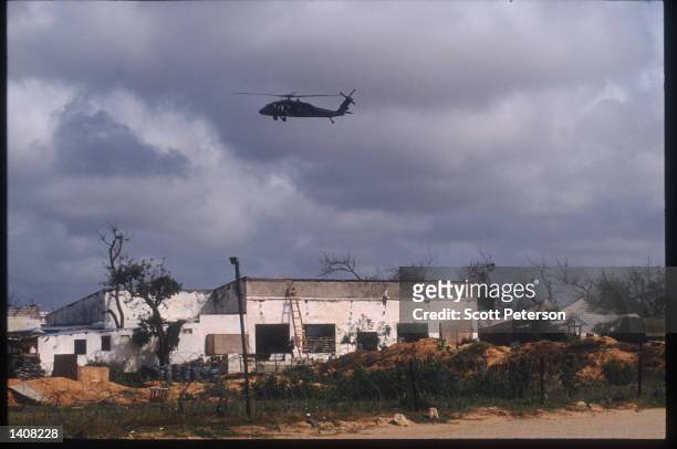 Army helicopter flies October 13, 1993 over Mogadishu, Somalia. Two US Army Airborne Ranger''s helicopters were shot down October 3, 1993 during a...