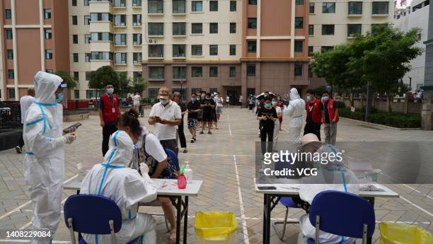 People queue up for COVID-19 nucleic acid tests on July 12, 2022 in Lanzhou, Gansu Province of China.