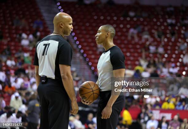 Sports analyst and former NBA player Richard Jefferson and referee Robert Hussy talk on the court as Jefferson officiates the second quarter of a...