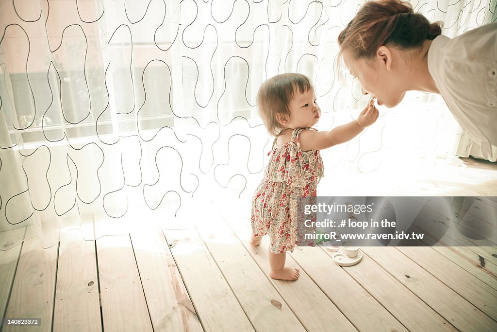 Daughter feeding mother