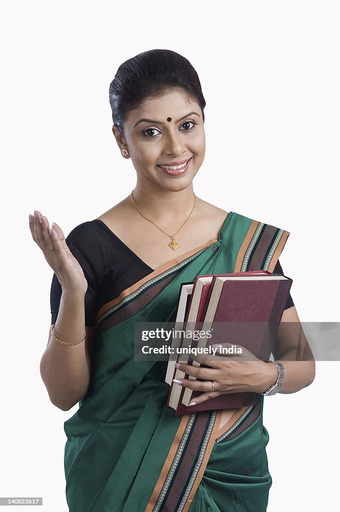 Portrait of a female teacher holding books