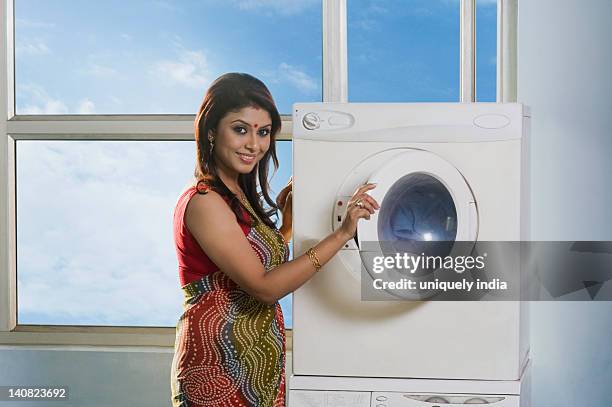 woman doing laundry - sari isolated stock pictures, royalty-free photos & images