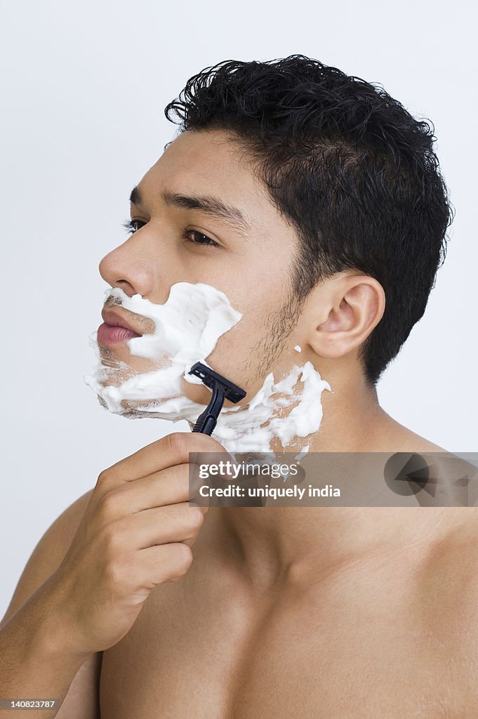 Man shaving his face