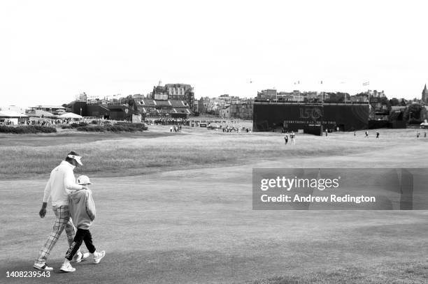 Ian Poulter of England makes their way down the 17th alongside their son Joshua during a practice round prior to The 150th Open at St Andrews Old...
