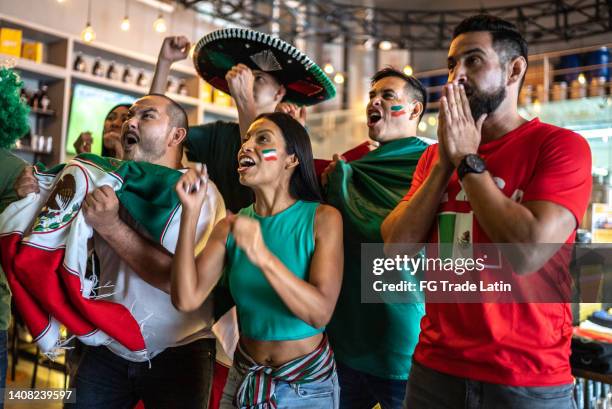 mexican fans watching a soccer game and celebrating at bar - world championship stock pictures, royalty-free photos & images