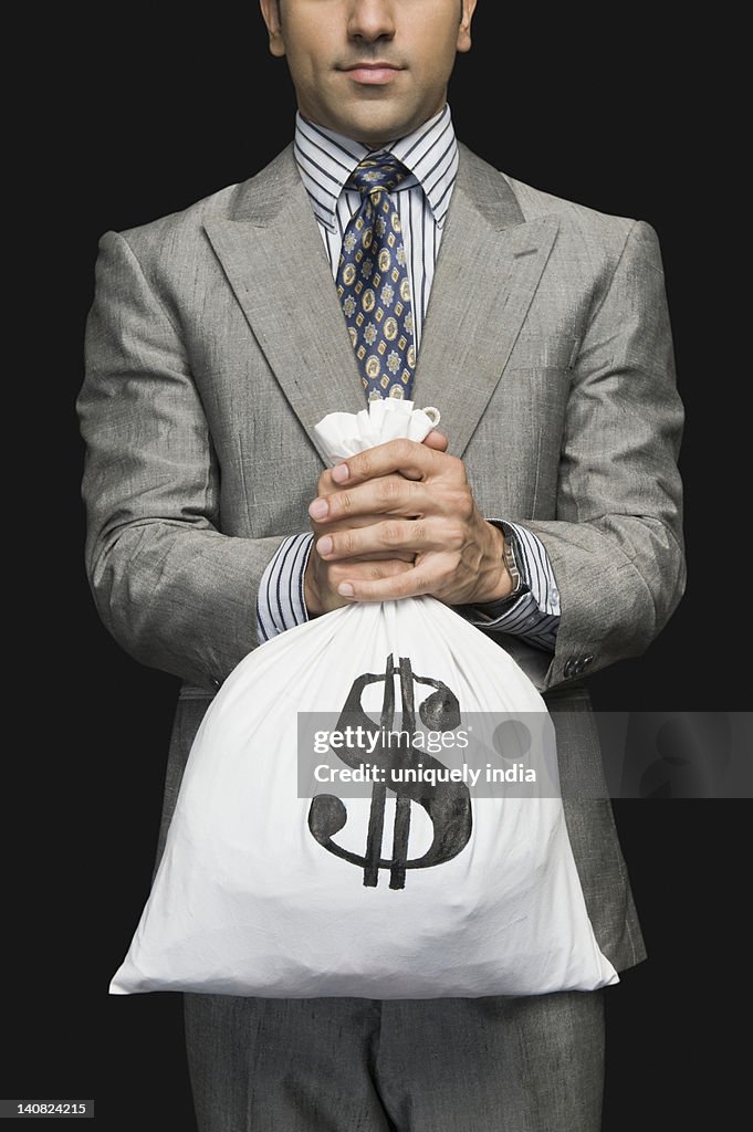 Businessman holding a money bag