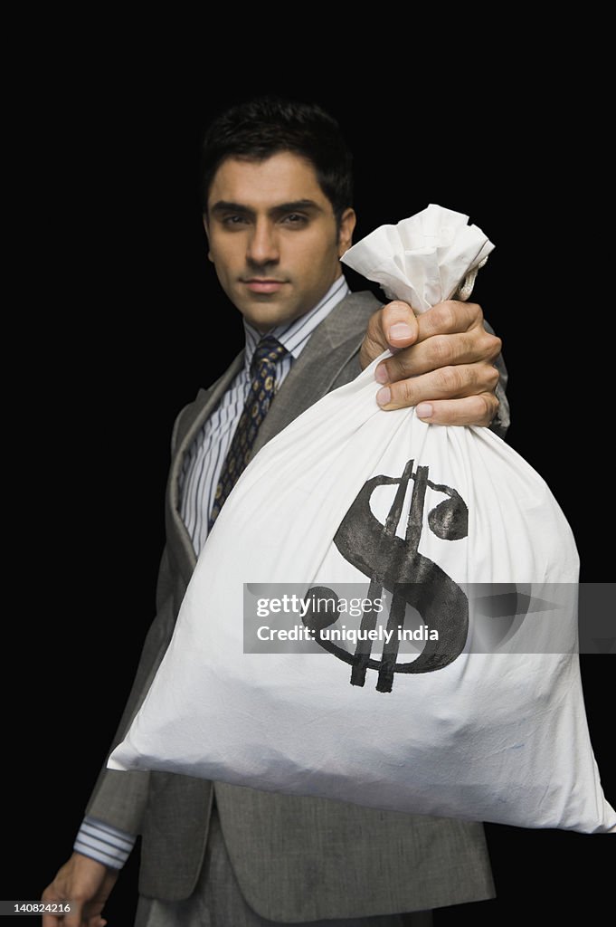 Businessman showing a money bag