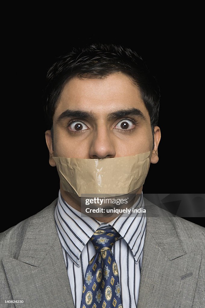 Portrait of a gagged businessman