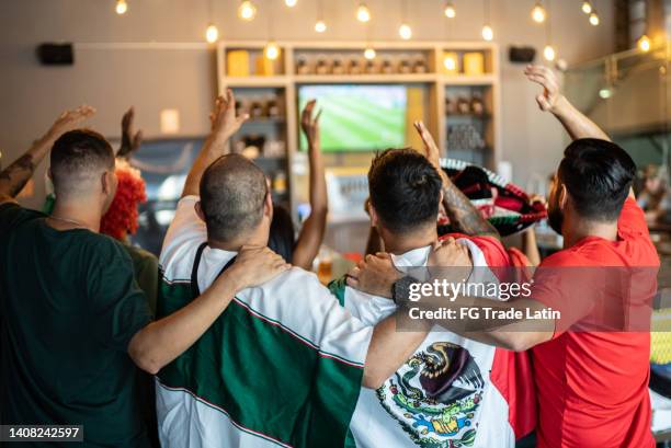 mexican fans celebrating a goal in soccer game at bar - mexico soccer bildbanksfoton och bilder