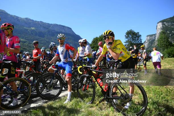 Tadej Pogacar of Slovenia and UAE Team Emirates - Yellow Leader Jersey and a general view of the peloton stopped due to protesters in defending "Mont...