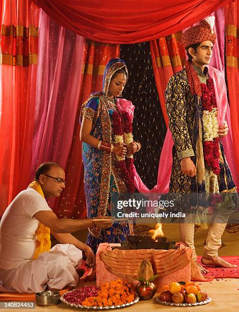 couple performing saptapadi ceremony in wedding mandap - hindu wedding ceremony stock pictures, royalty-free photos & images