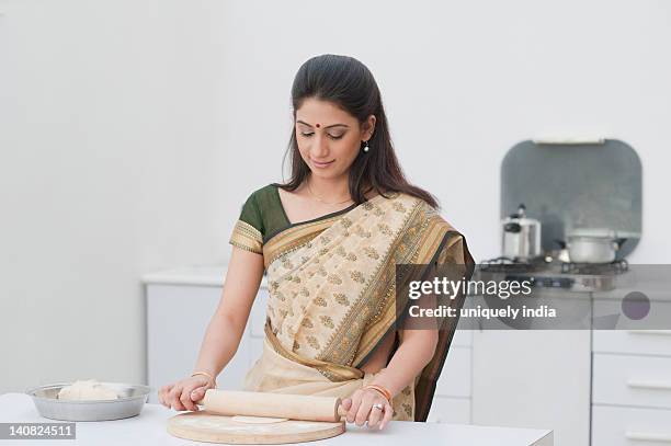 woman making chapatti in the kitchen - rolling pin stock pictures, royalty-free photos & images