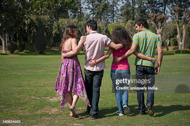 friends enjoying in a garden - long straight black hair stock pictures, royalty-free photos & images