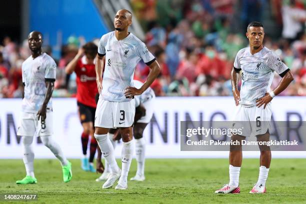 Naby Keita, Fabinho and Thiago Alcantara of Liverpool react after conceding their fourth goal to Manchester United during the second half of a...