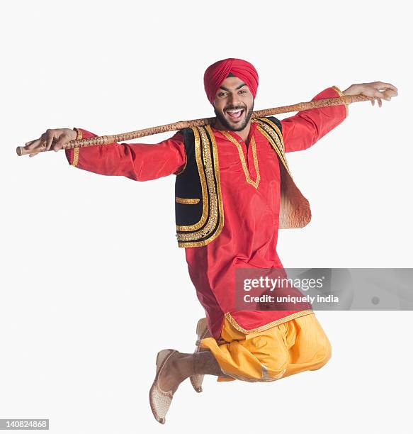 man doing bhangra the folk dance of punjab in india - folk stock-fotos und bilder