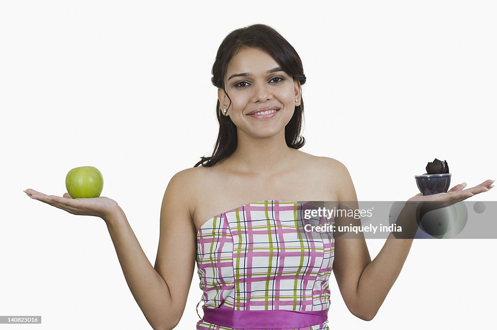 Woman holding a cup of ice cream with a green apple