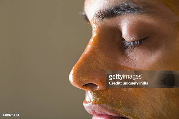 close-up of a man with peel off mask - peel off mask stock-fotos und bilder