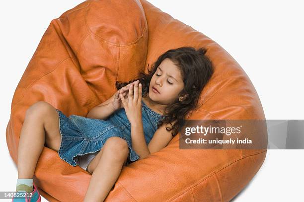 Girl Relaxing On A Bean Bag And Wishing, Foto de stock