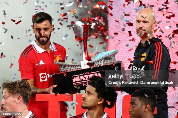 Bruno Fernandes and manager Erik ten Hag of Manchester United lift the match trophy after defeating Liverpool 4-0 during a preseason friendly match...
