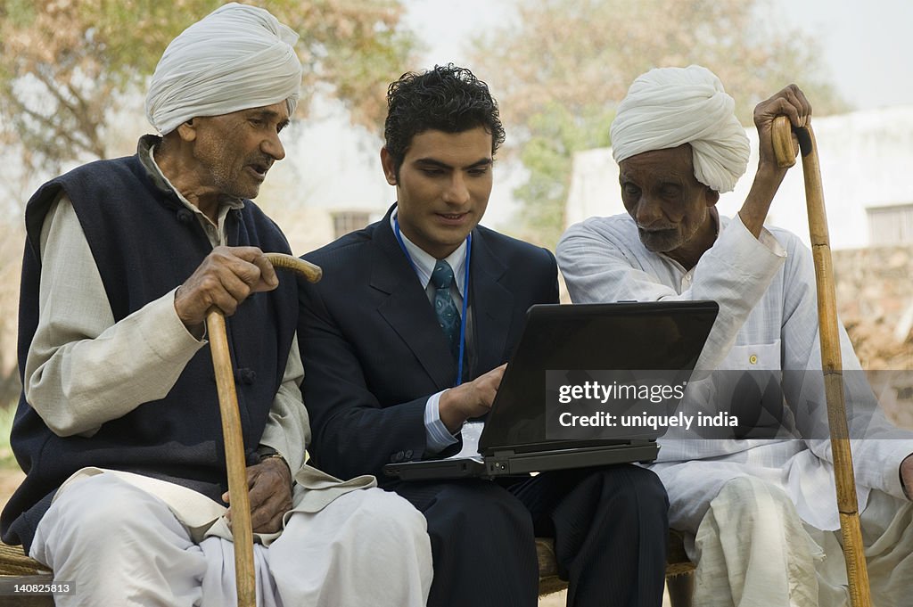 Financial advisor explaining to farmers about agriculture loan, Hasanpur, Haryana, India