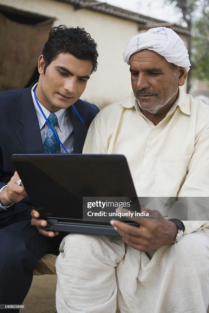 Financial advisor explaining to a farmer about agriculture loan, Hasanpur, Haryana, India