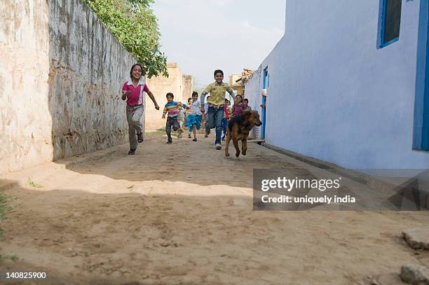 children running in a street, hasanpur, haryana, india - indian subcontinent ストックフォトと画像