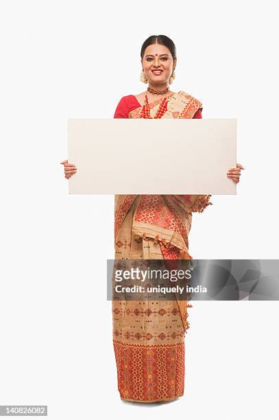 portrait of a woman holding a blank placard and smiling - bihu stock pictures, royalty-free photos & images