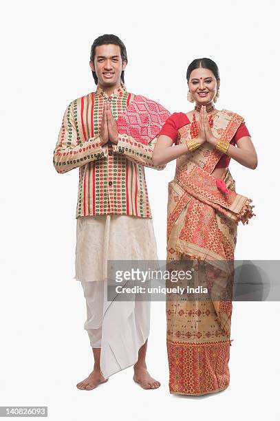 portrait of a couple greeting in traditional clothing - bihu stock pictures, royalty-free photos & images
