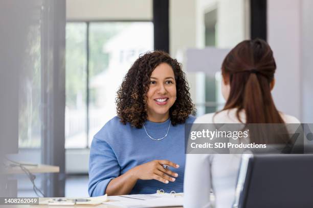 female co-workers meet to discuss project - employee review stock pictures, royalty-free photos & images