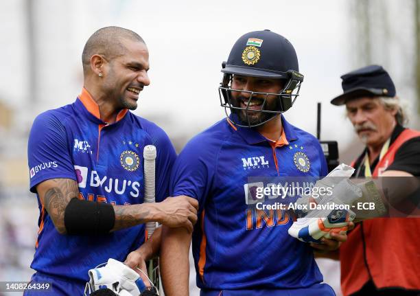 Shikhar Dhawan and Rohit Sharma of India walk off after the 1st Royal London Series One Day International at The Kia Oval on July 12, 2022 in London,...