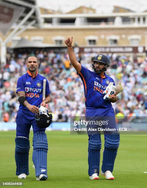 Shikhar Dhawan and Rohit Sharma of India walk off after the 1st Royal London Series One Day International at The Kia Oval on July 12, 2022 in London,...