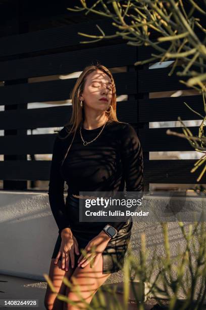 beautiful young woman enjoying sun - sun on face stock-fotos und bilder