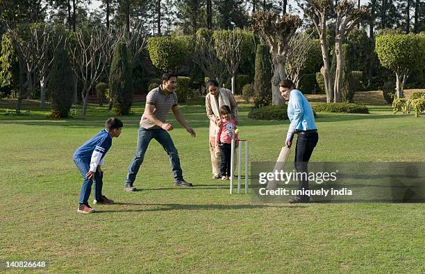 family playing cricket in lawn - indian boy standing stock pictures, royalty-free photos & images