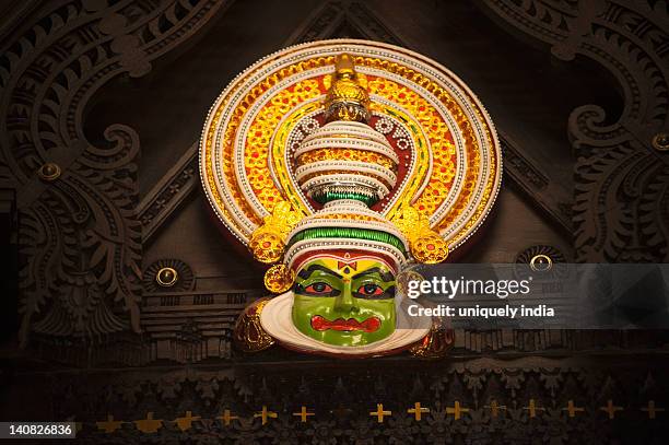 kathakali mask hanging with a wooden frame, kochi, kerala, india - kathakali stock pictures, royalty-free photos & images