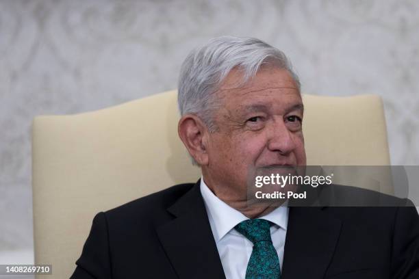 Mexican President Andres Manuel Lopez Obrador listens to U.S. President Joe Biden talk to journalists in the Oval Office at the White House on July...
